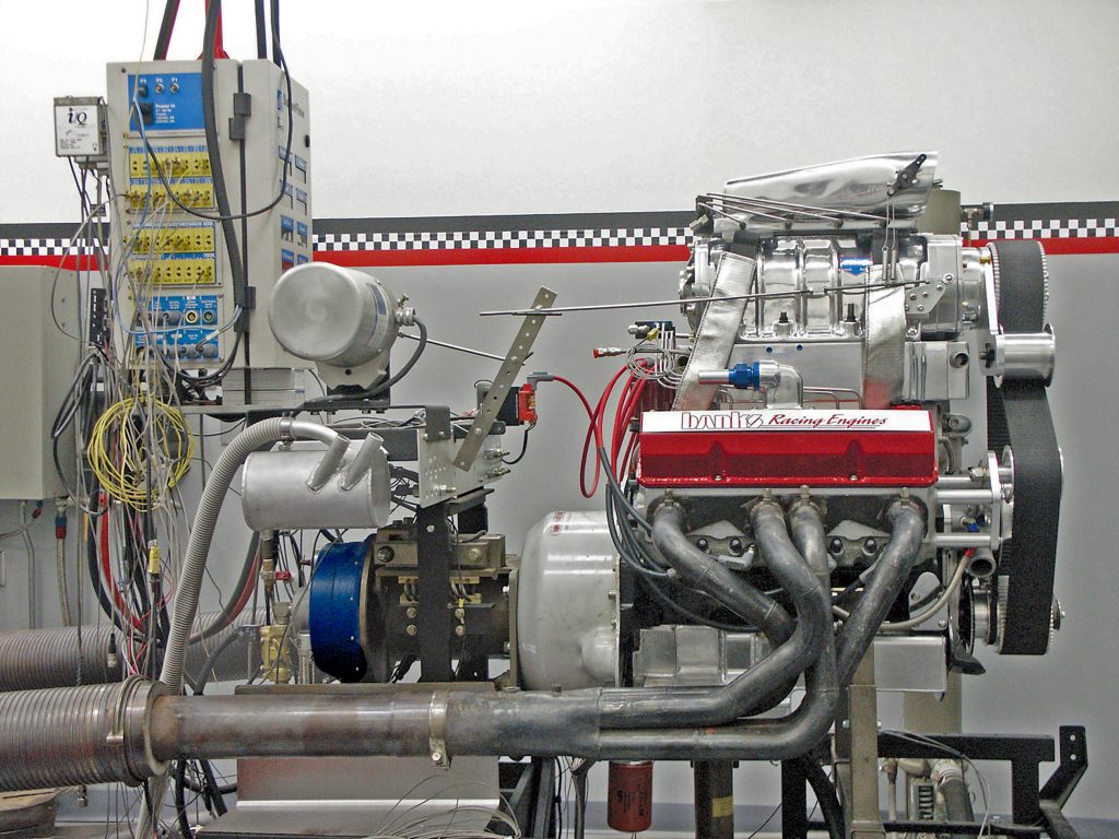 This amazing 257.5ci small-block Chevy with its 8-71 supercharger on top of an intercooler made over 700 hp on the dyno. The little engine revved to 10,200 rpm at the Bonneville salt flats. Note the aluminum box under the supercharger. This is a water-style intercooler for racing applications, thus using water to cool the compressed air mixture going into the engine. The intercooler must be fed cold water to work properly.