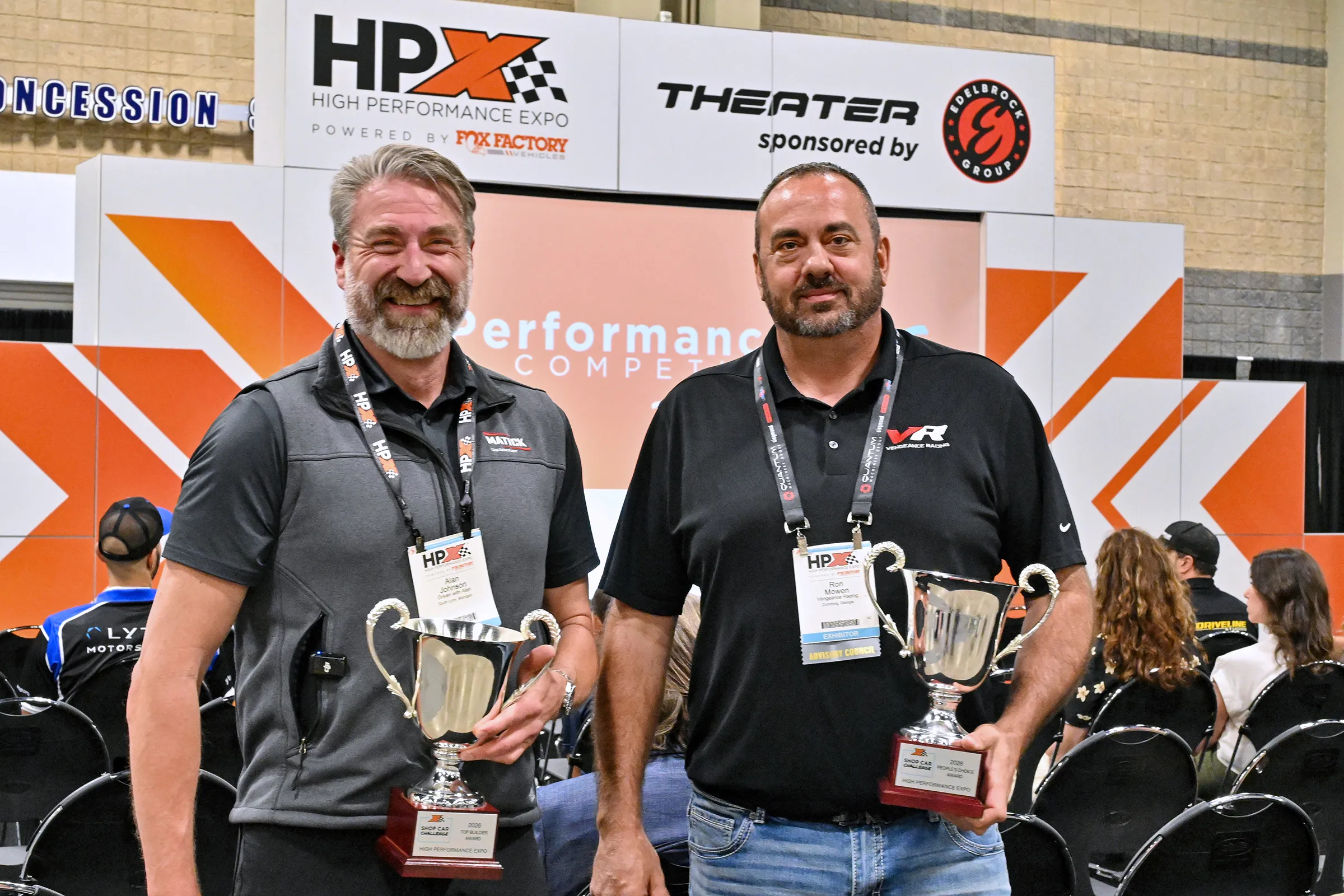 HPX Shop Car Challenge winners pose with their awards during HPX 2026 in Charlotte. Alan Johnson of Matick Chevrolet (left) earned the Top Builder Award for the TC Kline-built C8 Corvette road racer, while Ron Mowen of Vengeance Racing (right) received the People’s Choice Award for the shop’s C6 Corvette build.