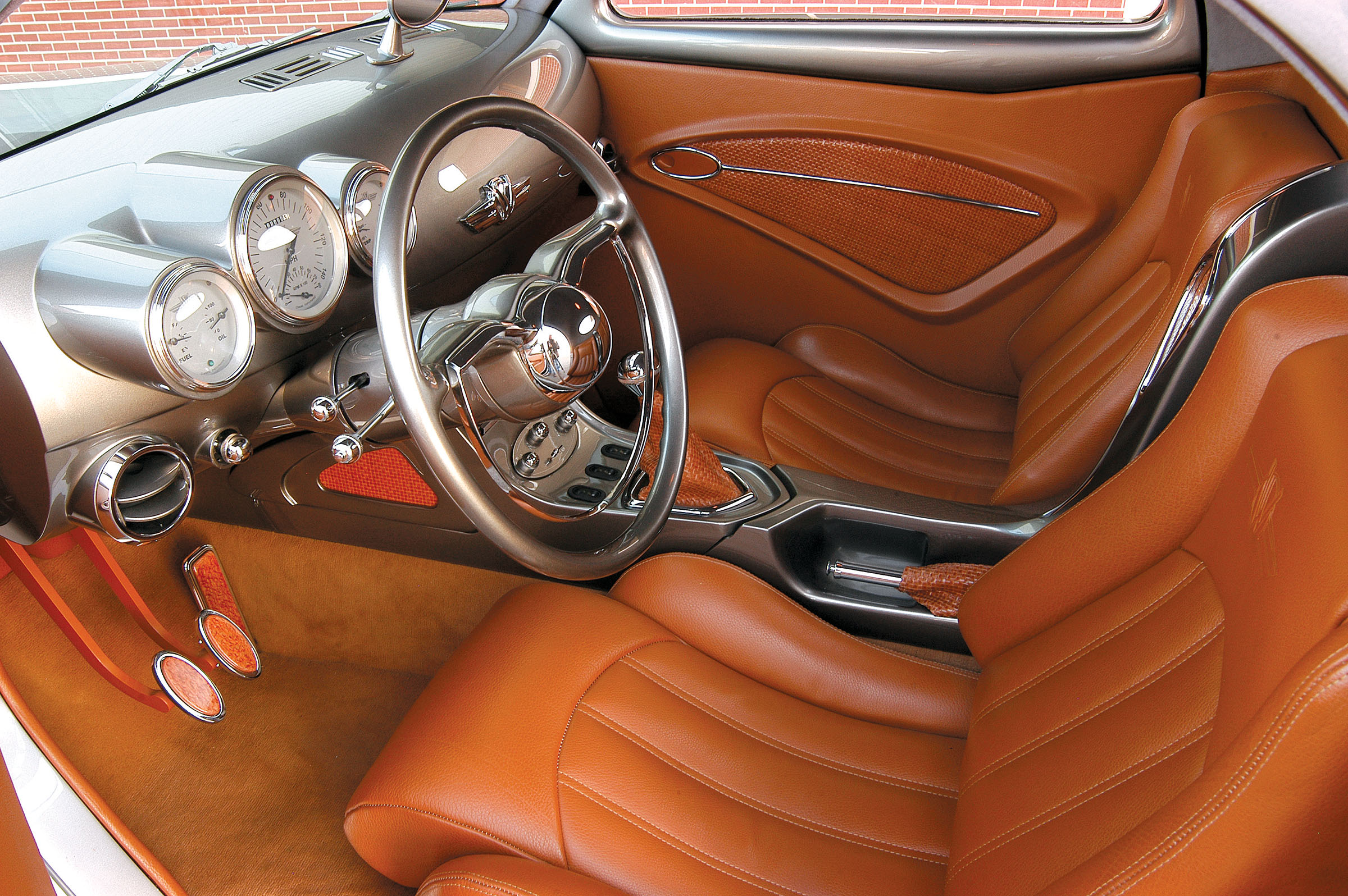 On the inside, we were drawn to the Willys emblem starter button, the Holden steering wheel, the custom console and dash, the gauge cluster, wood-accented pedals and other delights, all wrapped in beautiful upholstery with rich textures.