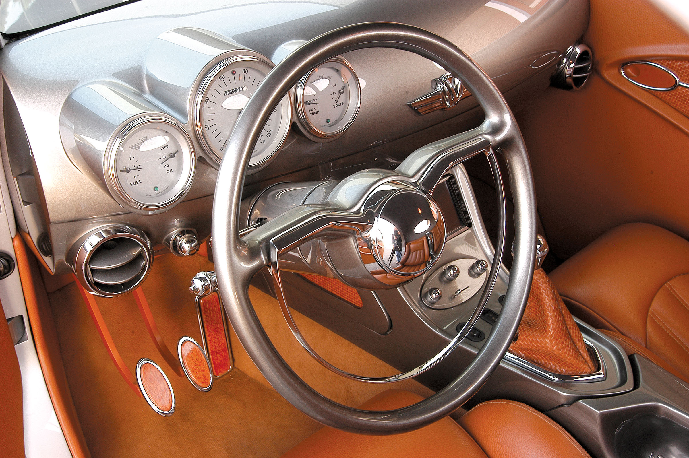 On the inside, we were drawn to the Willys emblem starter button, the Holden steering wheel, the custom console and dash, the gauge cluster, wood-accented pedals and other delights, all wrapped in beautiful upholstery with rich textures.